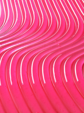 Pink lip gloss texture background. Smudged cosmetic product smear. Makup swatch product sample