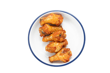 Fried spicy chicken wings in plate isolated on white