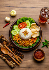 Flatlay of Indonesian uduk rice on a rustic wooden table
