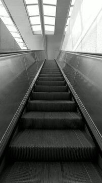 Vertical video of moving escalator going up. Motivational video. Background.