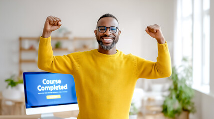 Man smiling and raising arms in victory after completing an online course. Modern, well-lit workspace filled with plants and technology. Concept of online education, achievement, personal growth