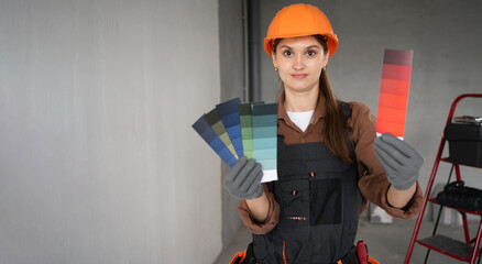 female painter showing color samples during interior renovation