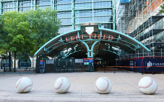 Entrance to the Left Field gate at Daikin Park in Houston, Texas, featuring four large decorative baseball sculptures in the foreground.  This photograph was taken 07 13 2025 in Houston Texas
