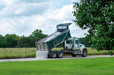 Dumping gravel on dirt road