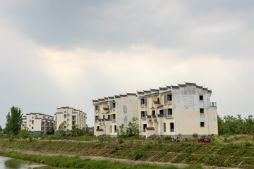 The unfinished building by the small river in Mianzhu New Year Picture Village, Deyang, Sichuan Province, China