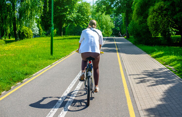 Fototapeta premium Cyclist ride on the bike path in the city Park 