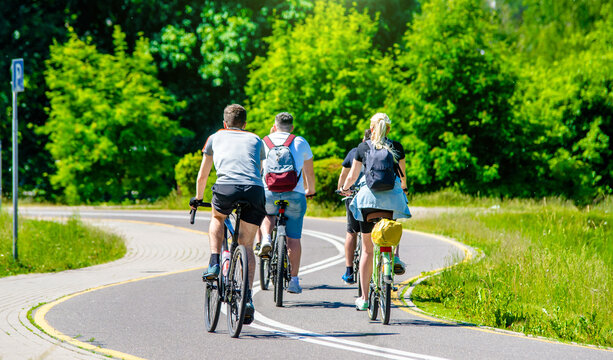 Cyclists ride on the bike path in the city Park
