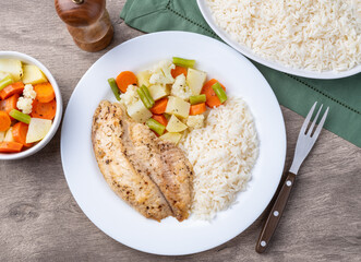Grilled tilapia or saint peter with rice and vegetables