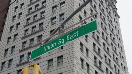 Static shot of Union Square East in New York City, highlighting the iconic street sign and modern architecture under an overcast sky