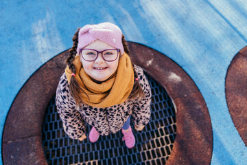Top view of cheerful girl with Down syndrome on playground