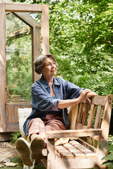Beautiful senior woman enjoying peaceful moments in a lush garden retreat