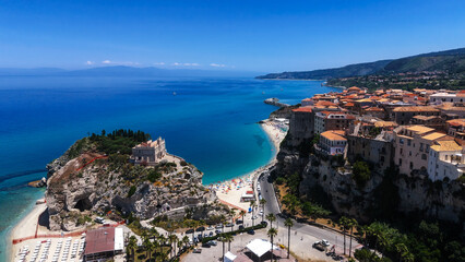 Naklejka premium Aerial view of Tropea, a charming town perched on a cliff overlooking the turquoise waters of the Tyrrhenian Sea in Calabria, Southern Italy