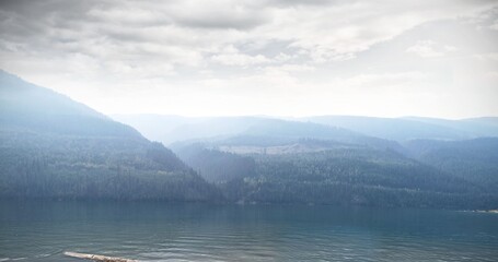 Scenic view of river by mountain against sky