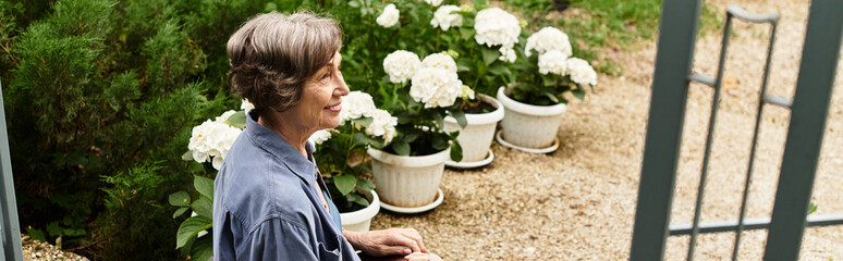 Radiating joy, a senior woman enjoys tranquility in her blooming garden