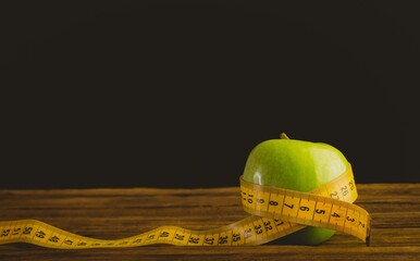 Green apple and measuring tape