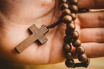Hand holding rosary beads
