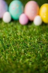 Fototapeta premium Easter eggs with focus on grass in garden