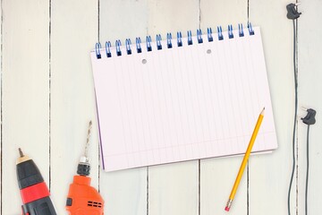 Tools and tablet on wooden background