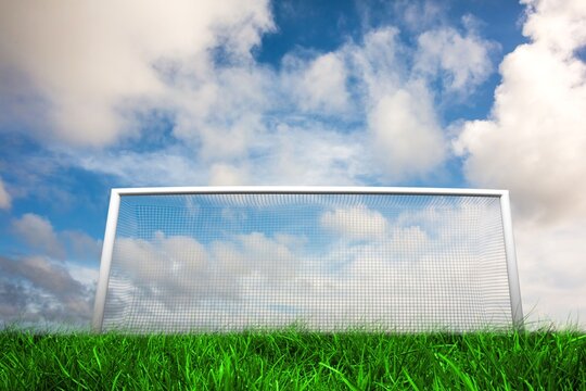 Fototapeta Football goal under blue cloudy sky