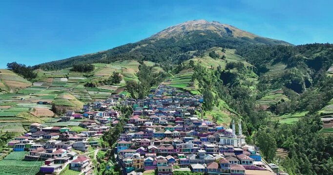 A village known as the &ldquo;Nepal of Java&rdquo; flows down the terraced slopes of the majestic Mount Sumbing under a clear blue sky.