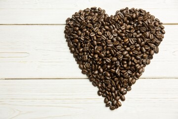 Showing heart-shaped dark coffee bean pile forming on painted white wooden plank in flat design