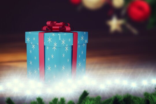 Fototapeta Blue snowflake gift box is sitting on wooden tabletop in flat design, with ribbon lights ornaments