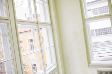 Fototapeta premium White-framed multi-pane windows are showing interior corner scene in flat design with plaster wall