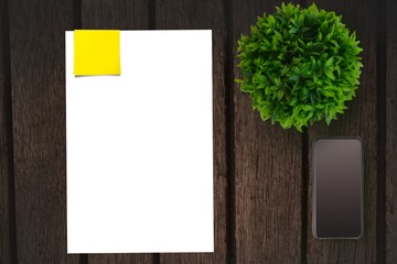 Table with a sheet of paper and a mobile phone