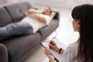 Professional psychologist working with patient in office, selective focus