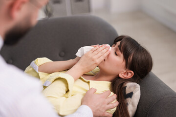Psychologist supporting patient during therapy session in office, selective focus
