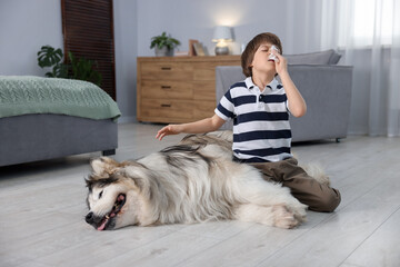 Boy suffering from allergy with her dog at home