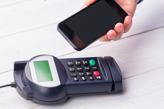 Man using smartphone to express pay