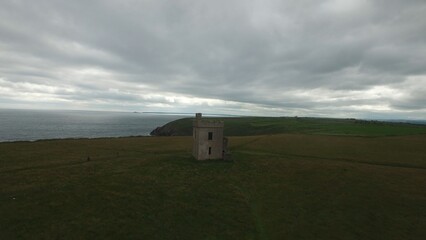 Built structure on hill by sea