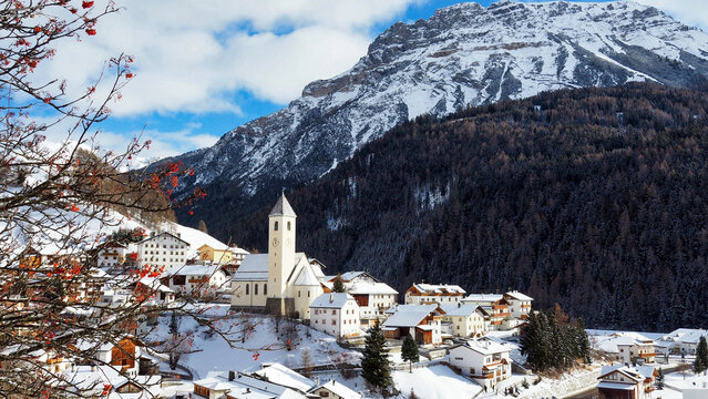 the picturesque village of Curon Venosta in winter with snow