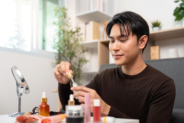 Beauty Routine. Man using serum dropper for skincare at home.