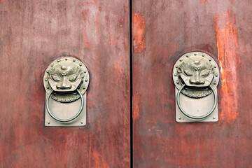 The lion-shaped door cymbals with animal faces on the gates of traditional Chinese architecture