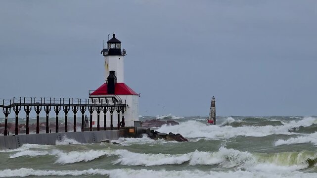 Video of the Michigan City, Indiana lighthouse and outer pier marker on Lake Michigan of the Great Lakes enduring the effects of huge waves generated by powerful gale force winds