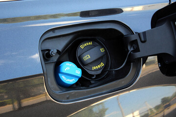 Black Car Fuel Cap. Car Fuel Neck. Black Vehicle with fuel door close and fuel cap.	