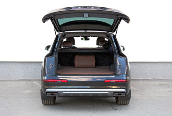 New black SUV open trunk. Modern electric car trunk. Vehicle is ready to load luggage. Modern car SUV with open empty trunk. Modern wagon car open trunk. Car boot is open.