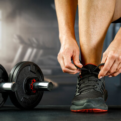 Close-up of fit woman training at gym, cropped fitness body with blurred background – concept of...