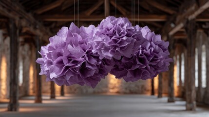 Two large fluffy purple tissue paper pom poms suspended indoors with a blurred background