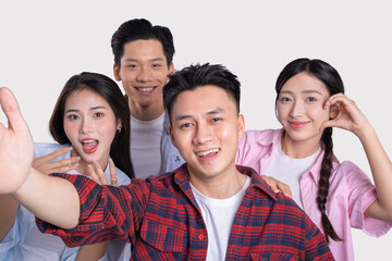 Group of smiling young adults taking a cheerful selfie together showing unity and friendship