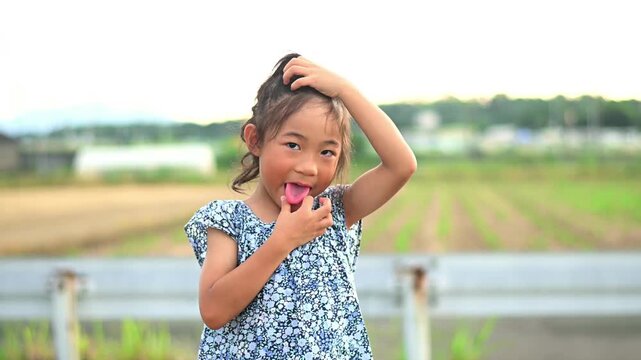 A little Asian girl pretending to be a monkey and a gorilla, doing animal gestures