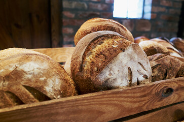 Wooden tray with a variety of breads on it