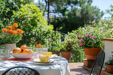 Table with potted flowers on sunny terrace