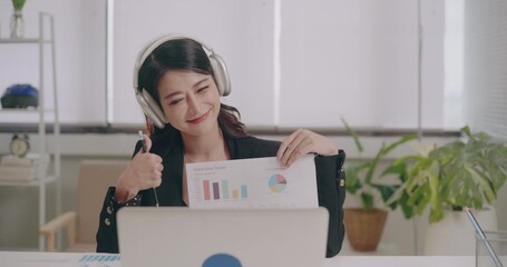 Asian businesswoman presenting financial charts during video conference with team online - Powered by Adobe