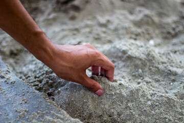 A man is holding some sands and the background is blurred