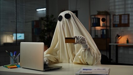Ghostly Figure Holding a Credit Card in an Office Setting