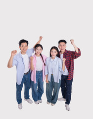 Obraz premium Diverse group of young adults celebrating success with raised fists and joyful expressions