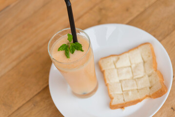 Milk melon Smoothie in glass with Roast bread